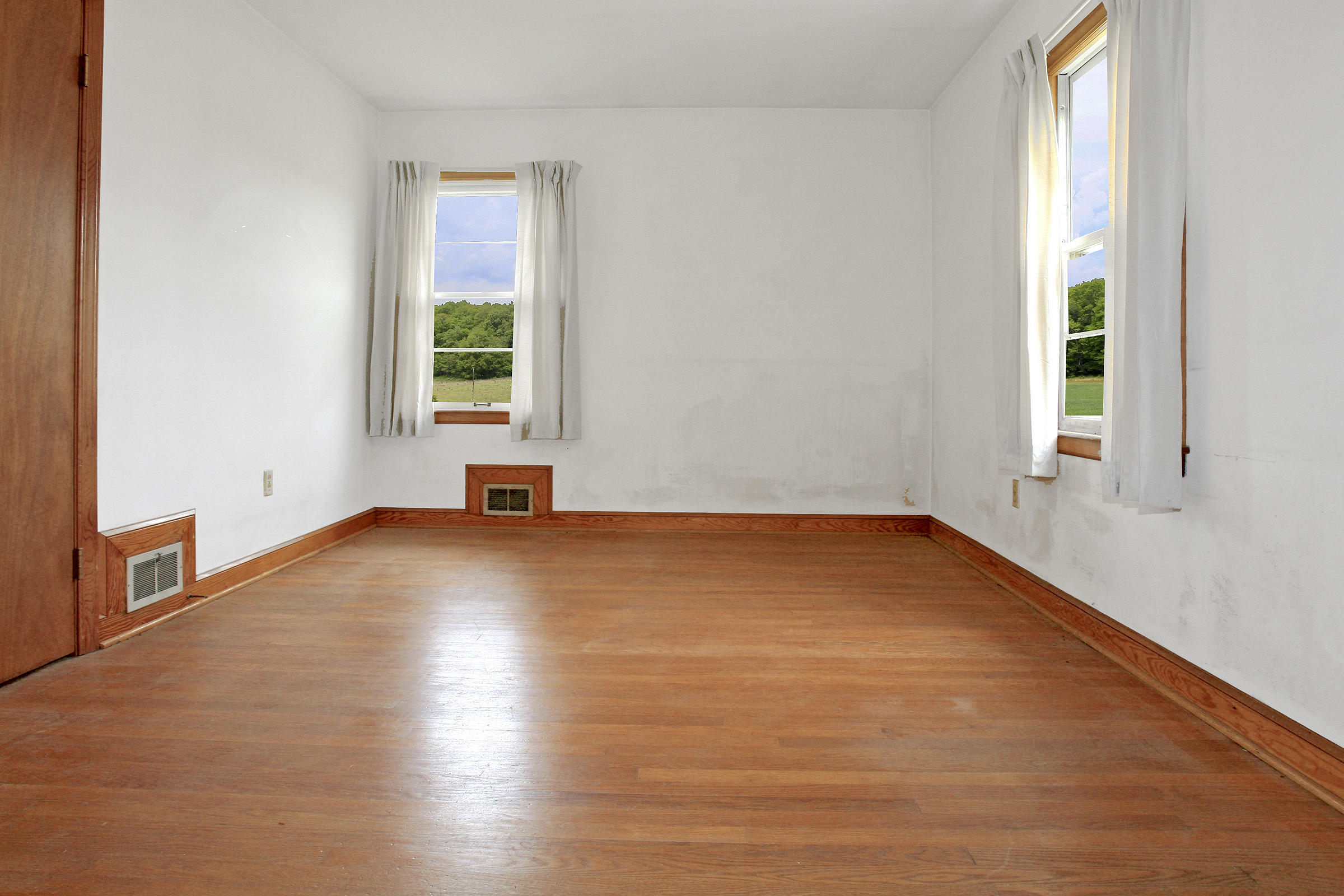 1058 Silverleaf Road Southeast Floyd, VA 24091 - Photo 13 of 55 a view of empty room with window and wooden floor