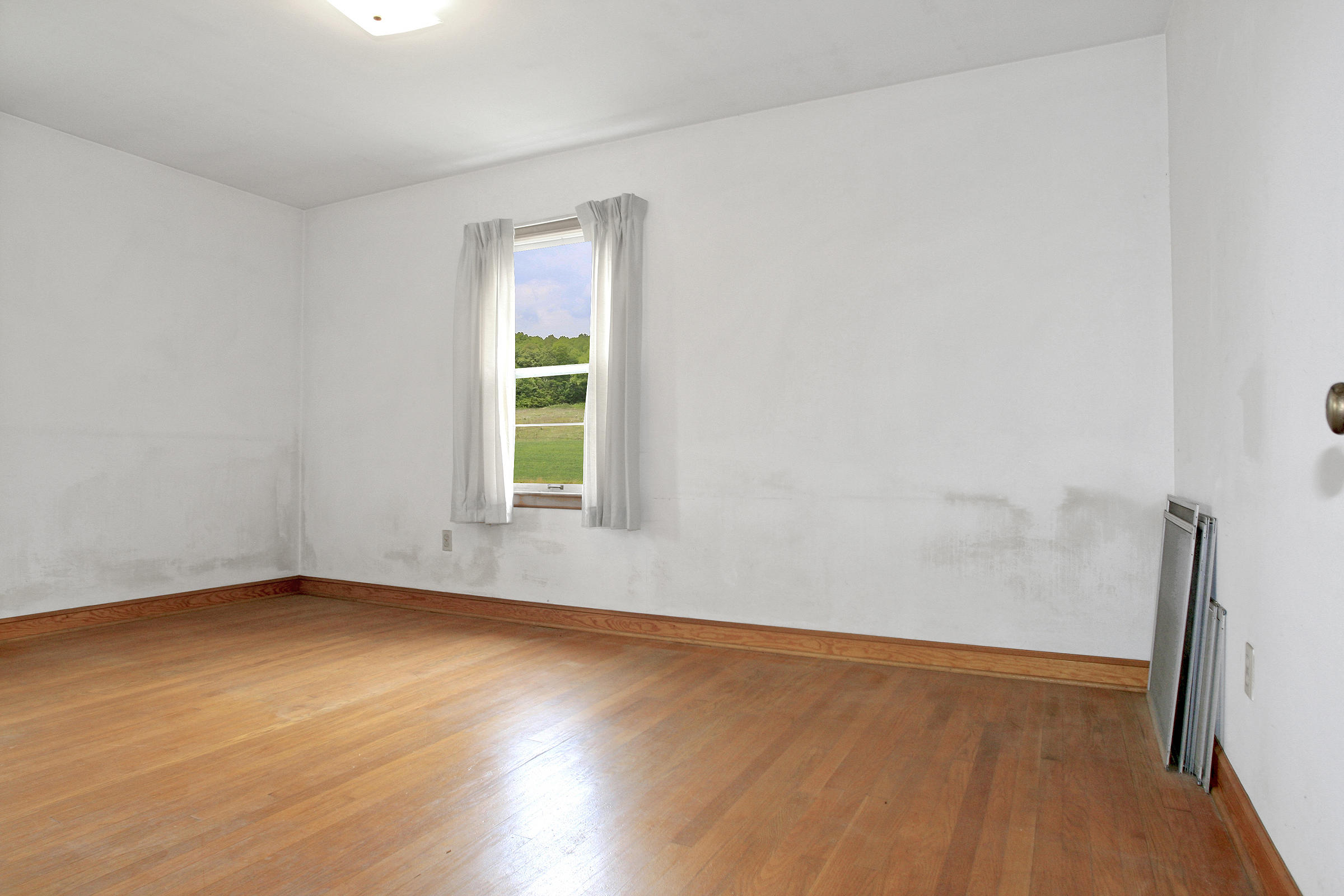 1058 Silverleaf Road Southeast Floyd, VA 24091 - Photo 15 of 55 an empty room with wooden floor and windows