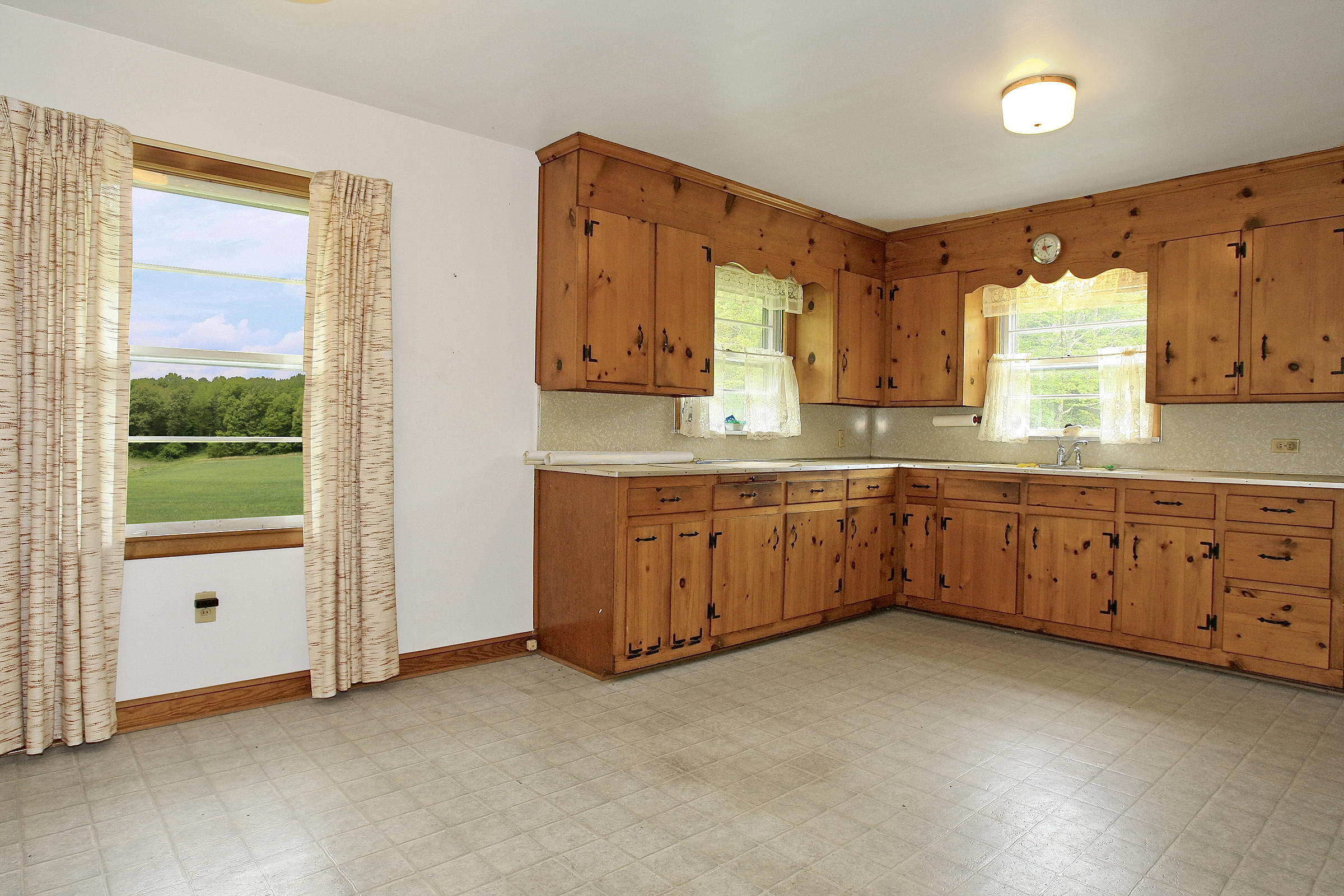 1058 Silverleaf Road Southeast Floyd, VA 24091 - Photo 17 of 55 a kitchen with cabinets a sink and a window