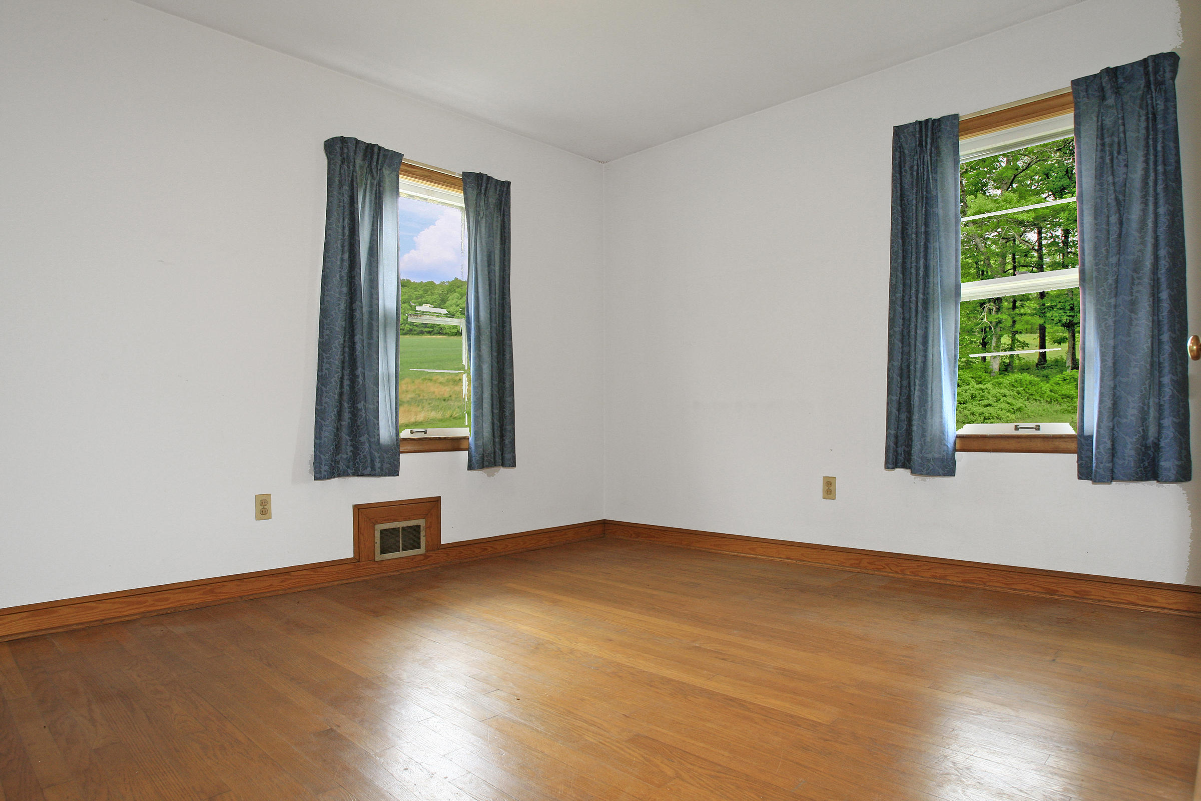 1058 Silverleaf Road Southeast Floyd, VA 24091 - Photo 19 of 55 a view of an empty room with wooden floor and a window