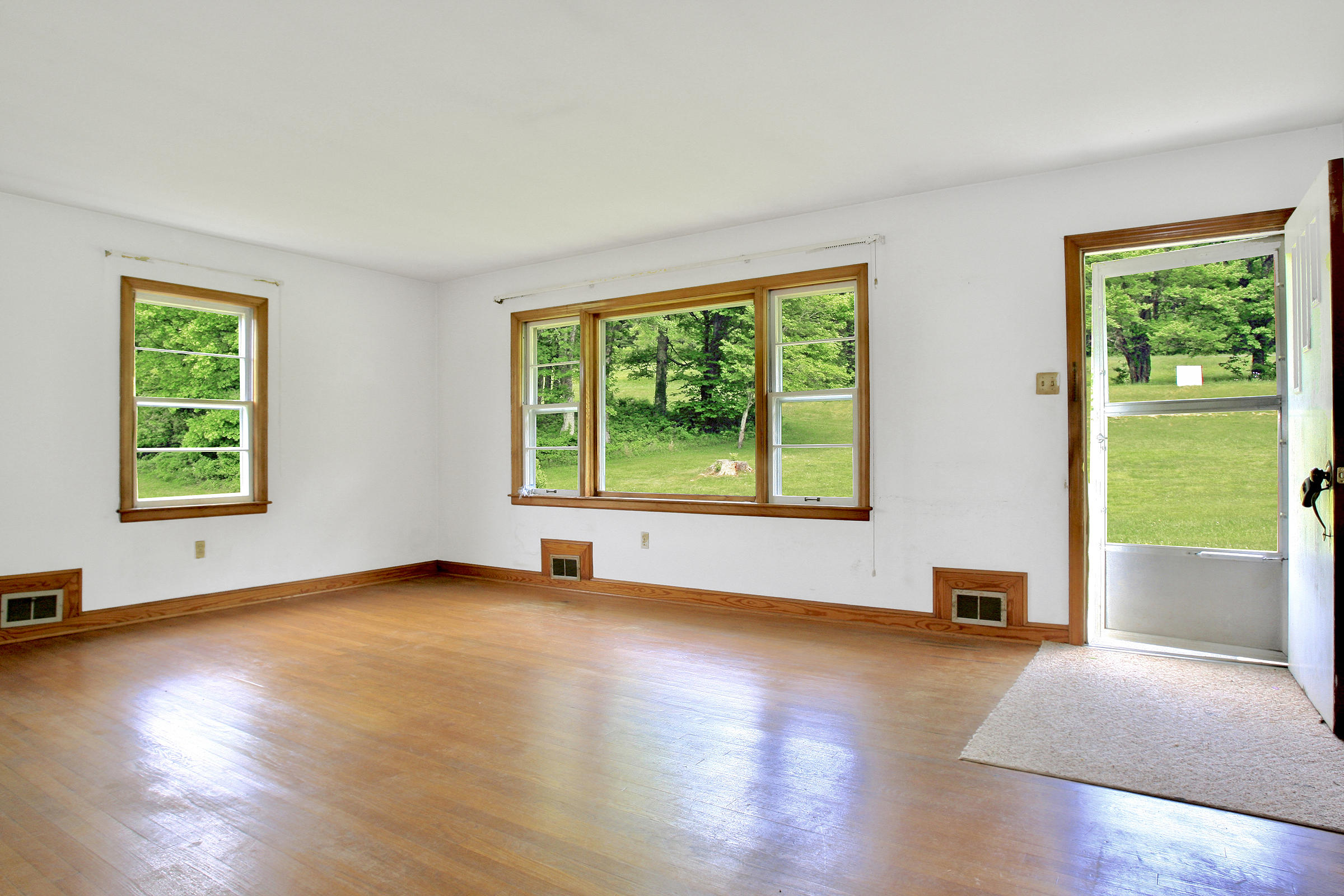 1058 Silverleaf Road Southeast Floyd, VA 24091 - Photo 7 of 55 a view of an empty room with a window and wooden floor
