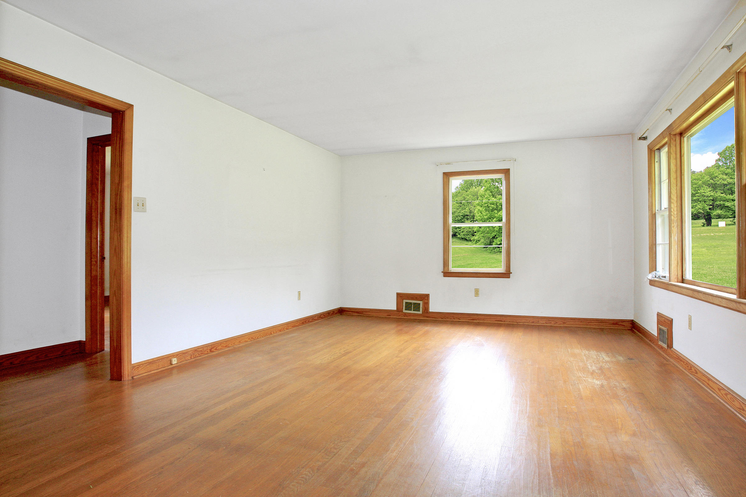 1058 Silverleaf Road Southeast Floyd, VA 24091 - Photo 9 of 55 an empty room with wooden floor and windows