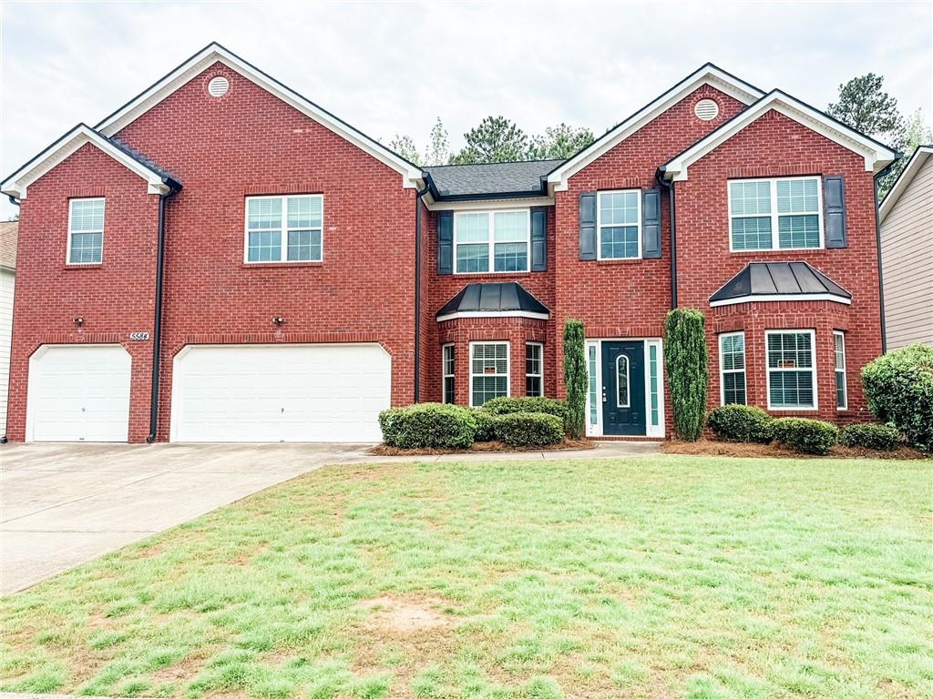 a front view of a house with a yard