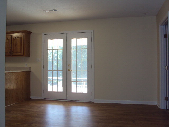 155 Girl Scout Road Lizella, GA 31052 - Photo 12 of 36 a view of an empty room with wooden floor and a window