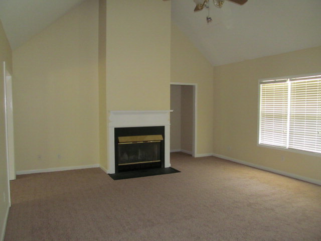 155 Girl Scout Road Lizella, GA 31052 - Photo 15 of 36 a view of empty room with a fireplace