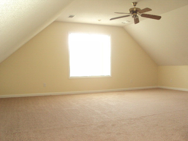 155 Girl Scout Road Lizella, GA 31052 - Photo 16 of 36 an empty room with a window and a ceiling fan