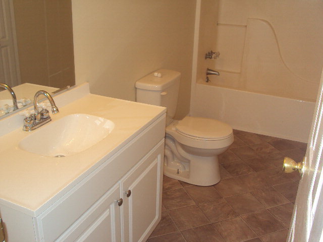 155 Girl Scout Road Lizella, GA 31052 - Photo 17 of 36 a bathroom with a sink a toilet and a mirror