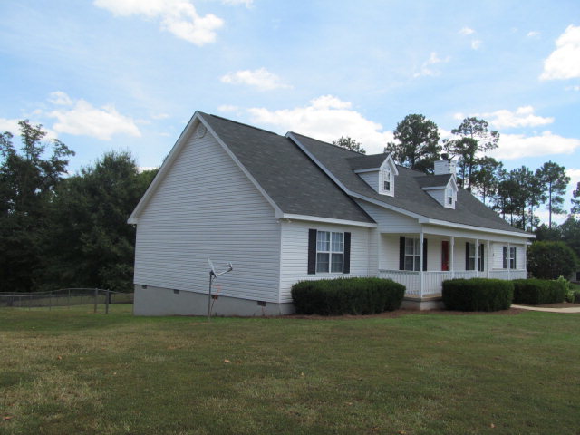 155 Girl Scout Road Lizella, GA 31052 - Photo 3 of 36 a house view with a garden space