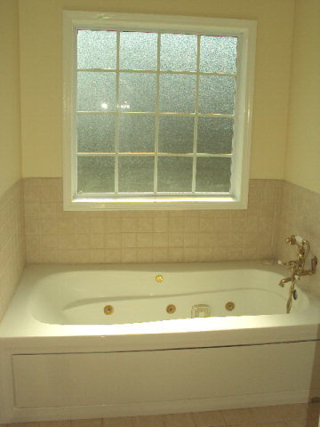 155 Girl Scout Road Lizella, GA 31052 - Photo 24 of 36 a bathroom with a bathtub and a shower