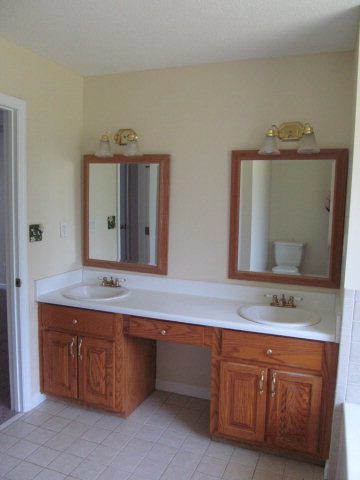 155 Girl Scout Road Lizella, GA 31052 - Photo 25 of 36 a bathroom with a granite countertop double vanity sink and a mirror