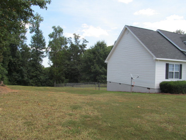 155 Girl Scout Road Lizella, GA 31052 - Photo 4 of 36 a view of a backyard with a garden