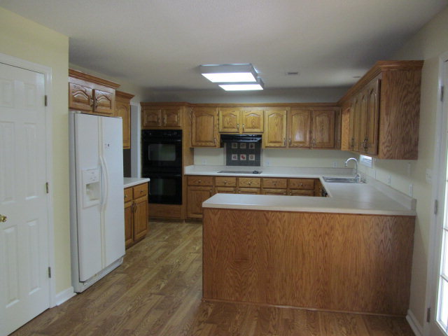 155 Girl Scout Road Lizella, GA 31052 - Photo 7 of 36 a kitchen with stainless steel appliances granite countertop a refrigerator a sink a stove and a refrigerator