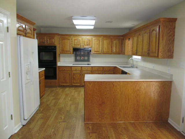 155 Girl Scout Road Lizella, GA 31052 - Photo 8 of 36 a kitchen with granite countertop sink and cabinets