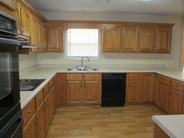 155 Girl Scout Road Lizella, GA 31052 - Photo 9 of 36 a kitchen with a sink a stove and cabinets
