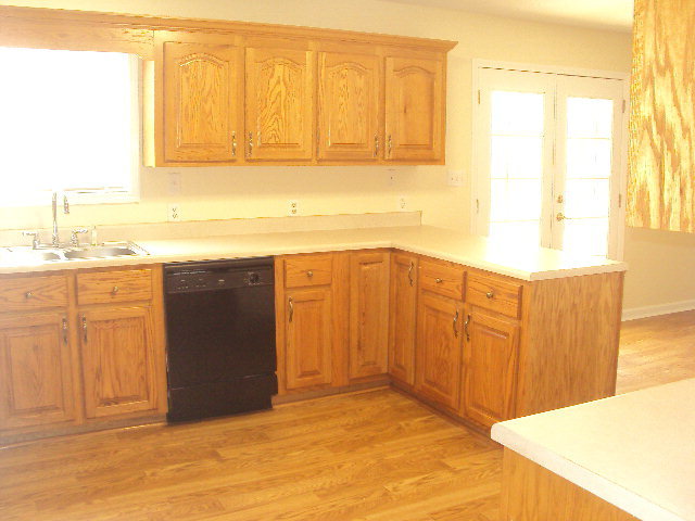 155 Girl Scout Road Lizella, GA 31052 - Photo 10 of 36 a view of a kitchen with wooden floor