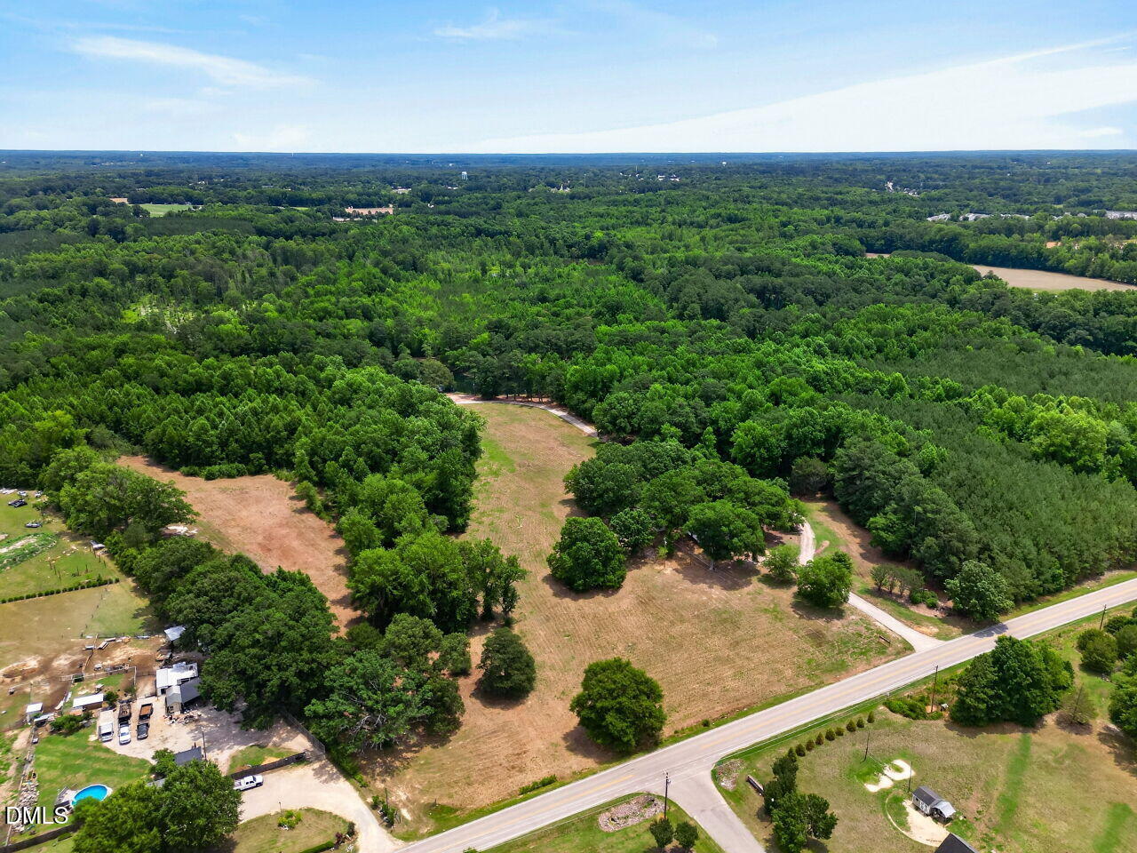 1217 Eagle Rock Road Wendell, NC 27591 - Photo 5 of 17 an aerial view of green landscape with trees houses and mountain view