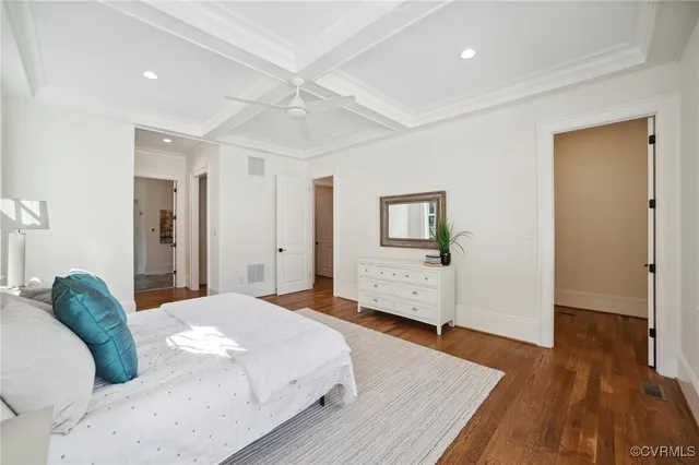 a bedroom with a bed and a wooden floor