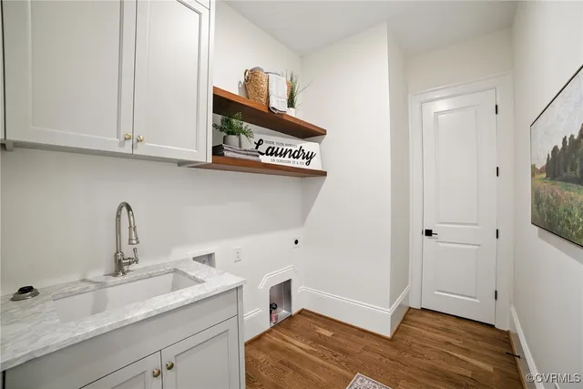 a view of a kitchen with sink and dishwasher with wooden floor