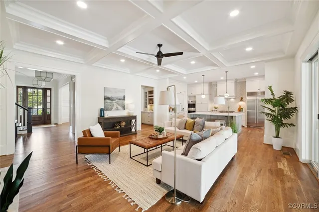 a living room with furniture and wooden floor