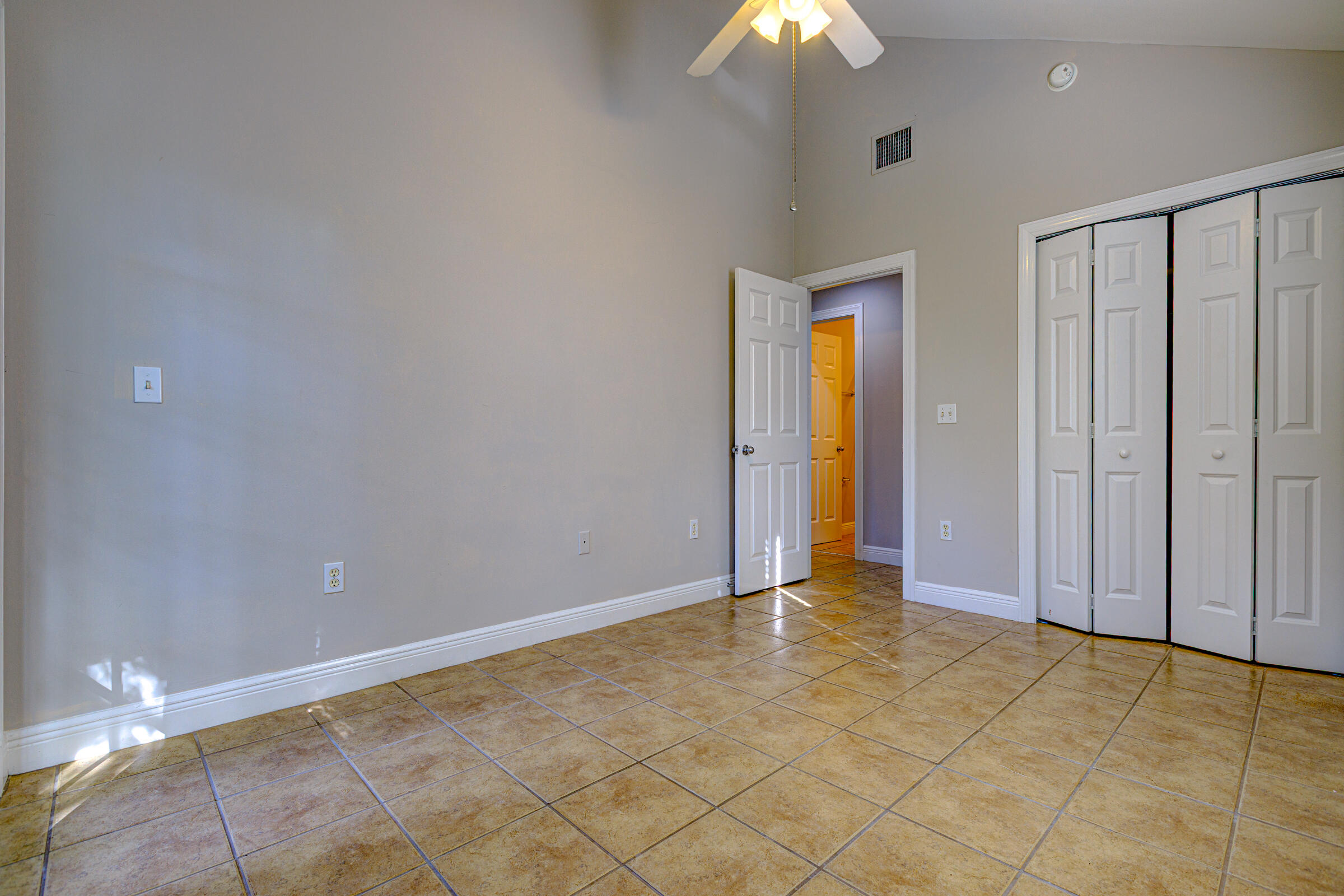 263 Golf Club Drive Key West, FL 33040 - Photo 24 of 30 a view of an empty room with a chandelier fan