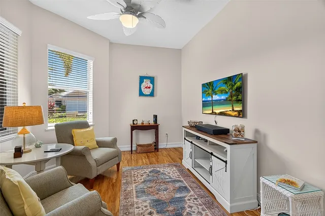 a kitchen with stainless steel appliances a dining table chairs sink and cabinets