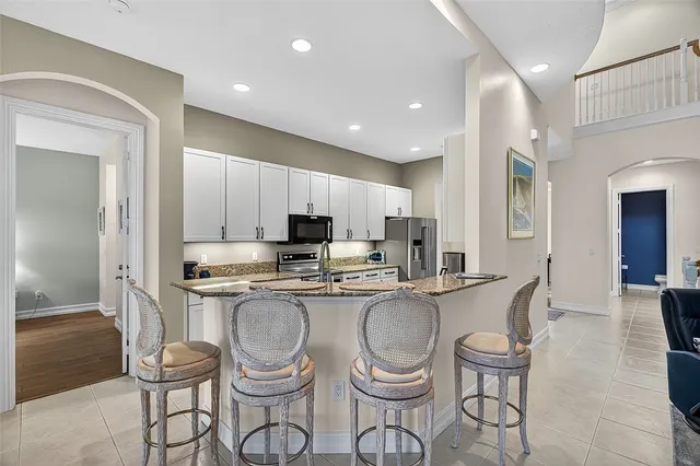 a bedroom with a large bed and a chandelier