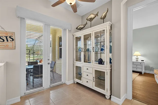 a bedroom with a bed and a table in it with wooden floor