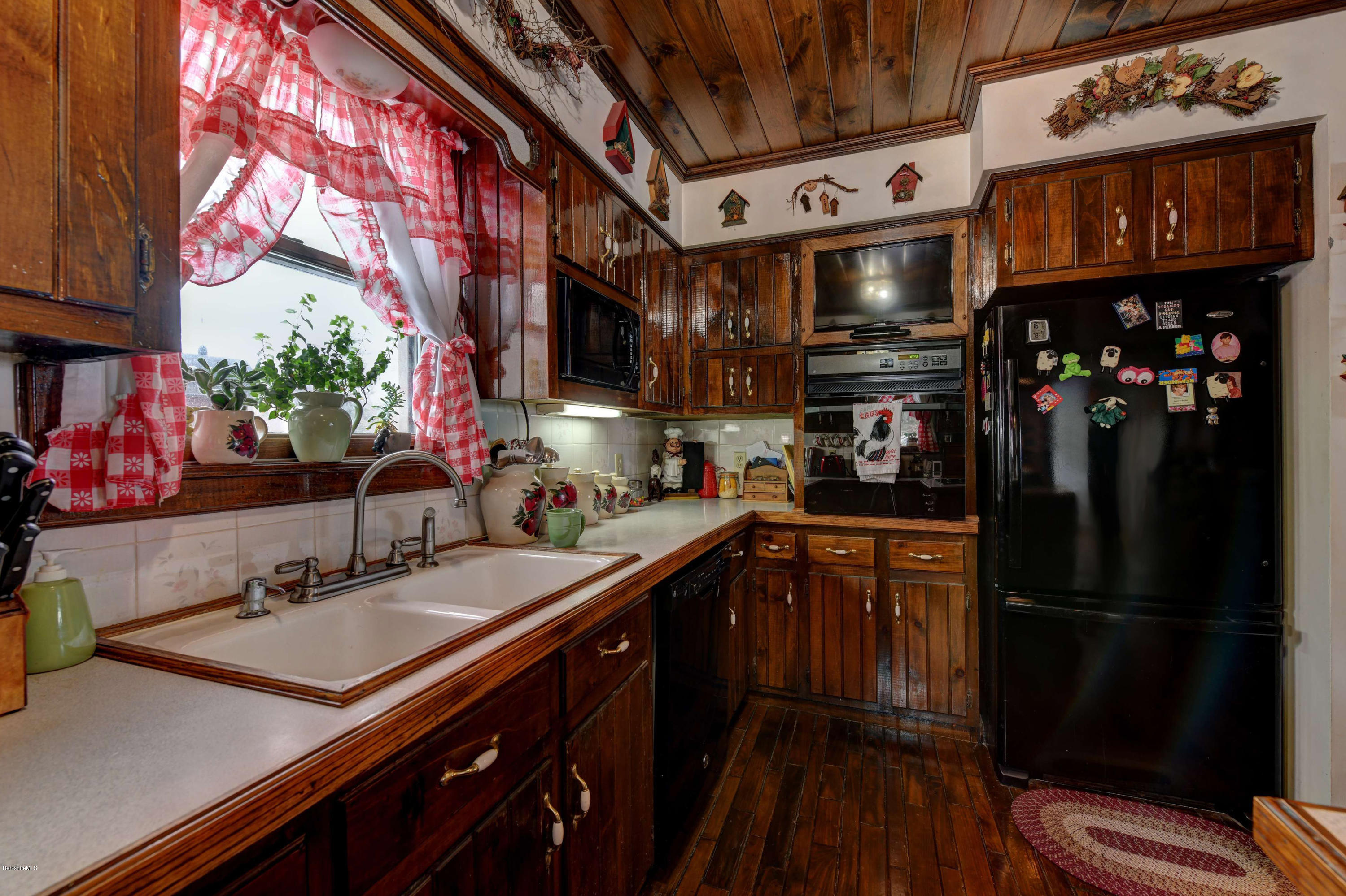 88 Moores Road Florida, MA 01343 - Photo 35 of 53 a kitchen with stainless steel appliances a sink cabinets and wooden floor