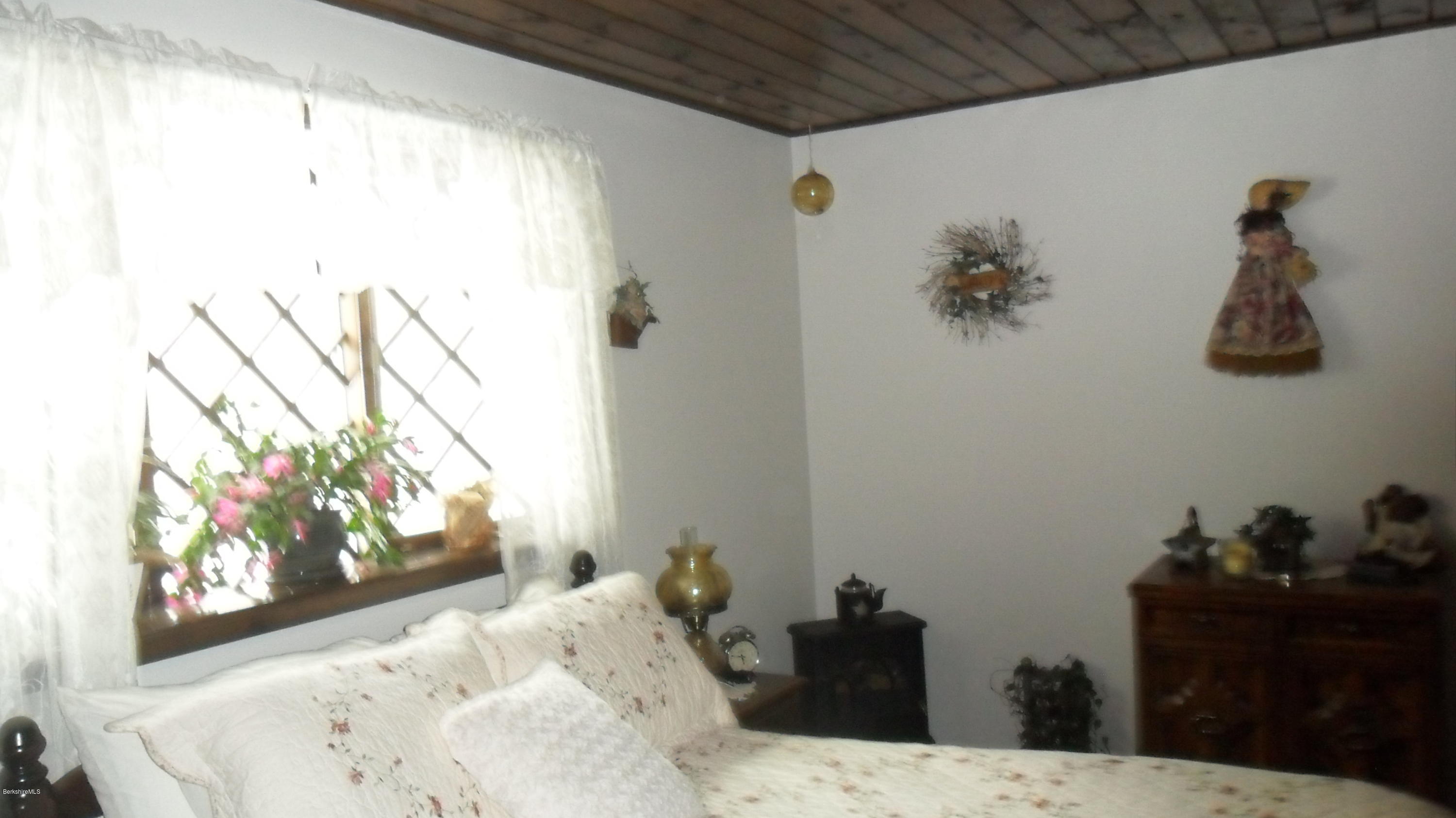 88 Moores Road Florida, MA 01343 - Photo 43 of 53 a view of a bedroom with a bed and wooden floor