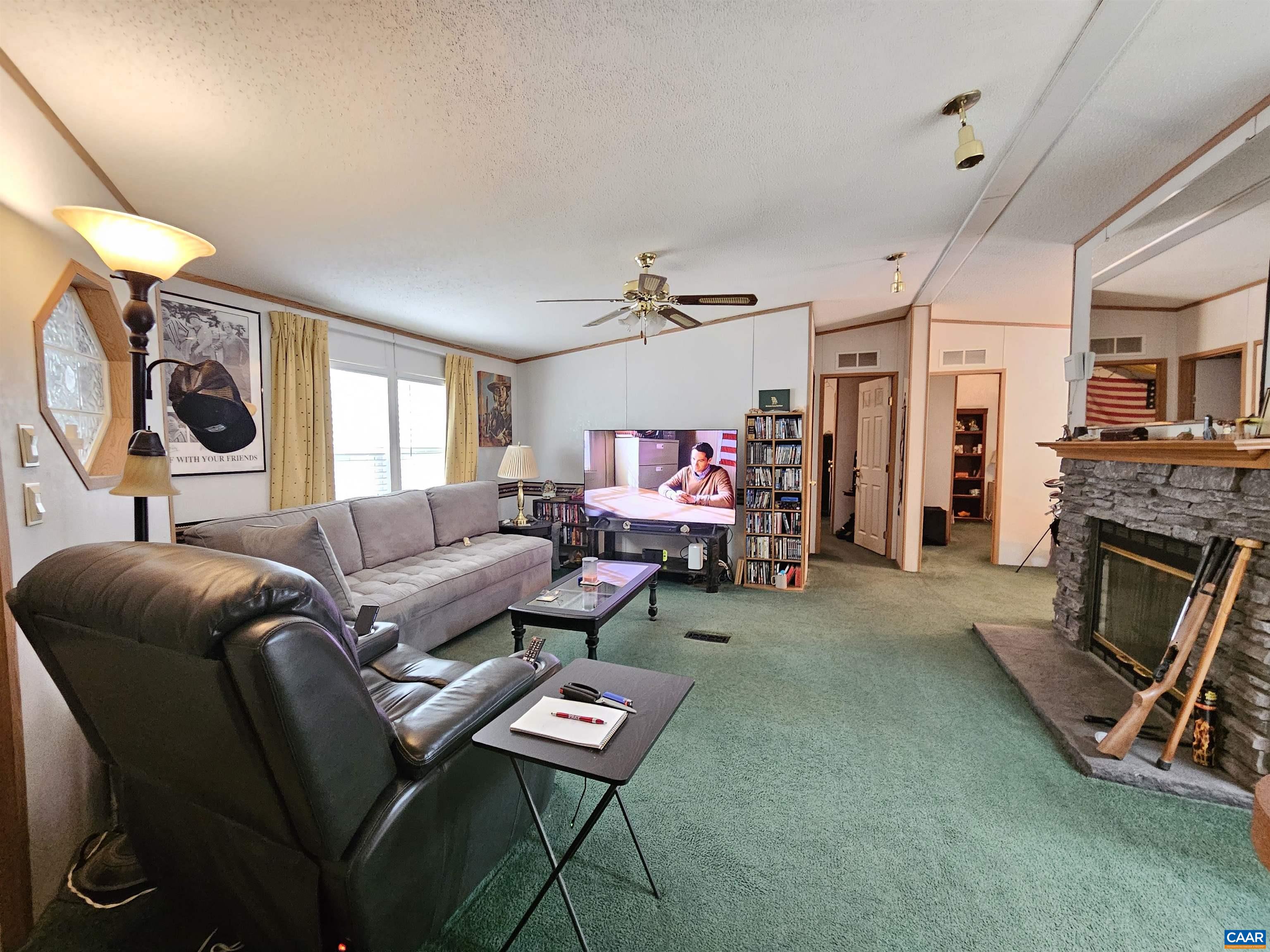 981 Scotts Bottom Road Dillwyn, VA 23936 - Photo 5 of 62 a living room with furniture a flat screen tv and a fireplace
