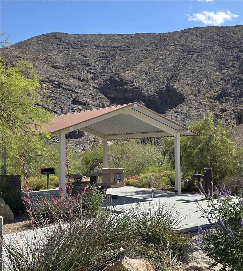 10550 West Alexander Road, Unit 2183 Las Vegas, NV 89129 - Photo 21 of 22 Enjoy outdoor dining and grilling in this covered patio space, nestled against a striking mountain backdrop.