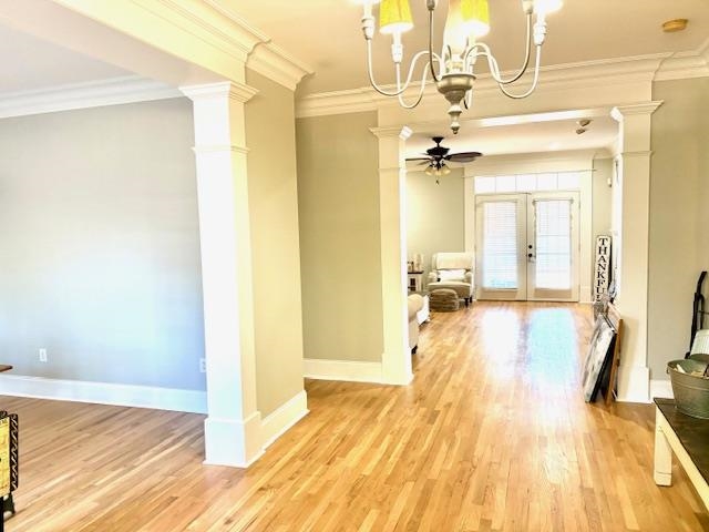 4310 Enoch Road Aynor, SC 29511 - Photo 11 of 39 Dining space featuring decorative columns, crown molding, light wood-style floors, a ceiling fan, and french doors