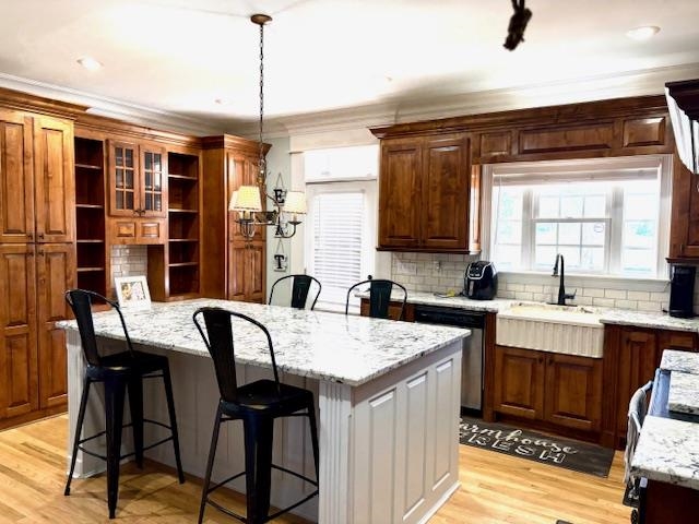 4310 Enoch Road Aynor, SC 29511 - Photo 14 of 39 Kitchen featuring light stone counters, a kitchen bar, a center island, white cabinetry, and stainless steel dishwasher
