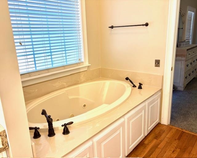 4310 Enoch Road Aynor, SC 29511 - Photo 17 of 39 Bathroom featuring a tub with jets and dark wood finished floors
