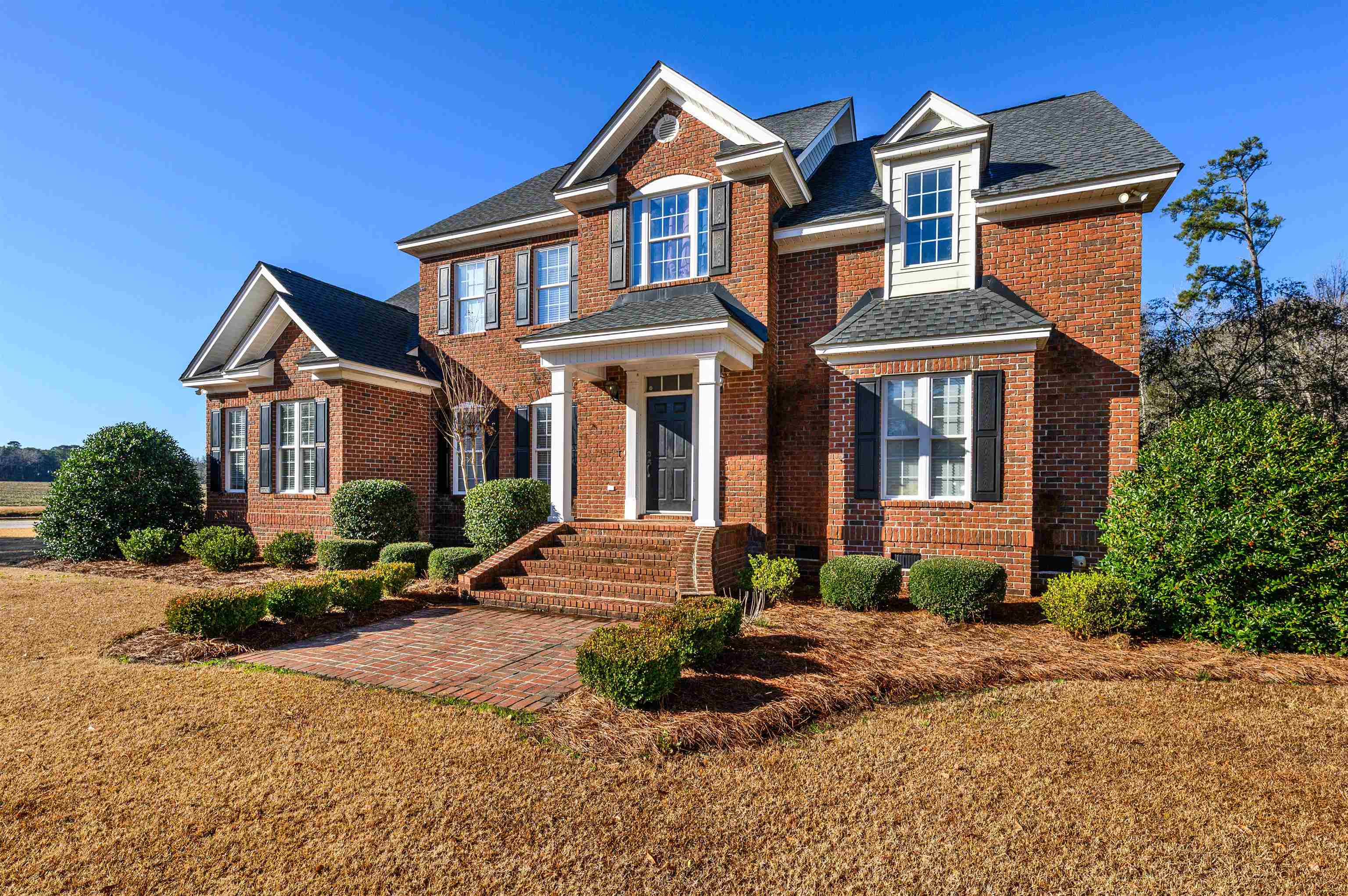 4310 Enoch Road Aynor, SC 29511 - Photo 32 of 39 View of front facade featuring brick siding, a front lawn, and roof with shingles