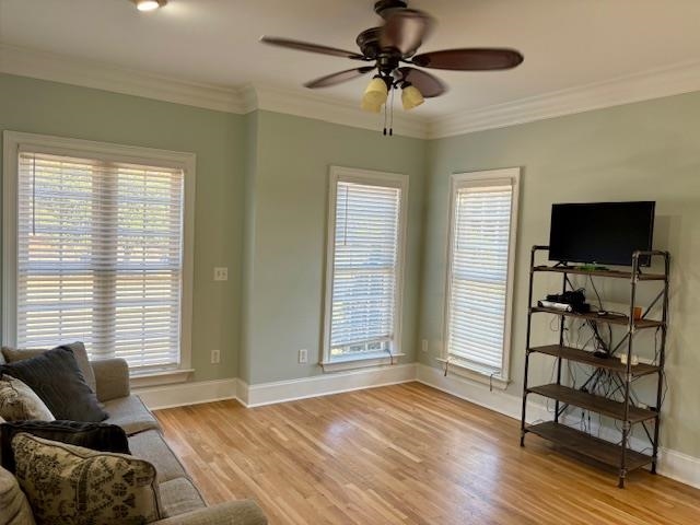 4310 Enoch Road Aynor, SC 29511 - Photo 9 of 39 Living area featuring light wood-style flooring, plenty of natural light, crown molding, and ceiling fan