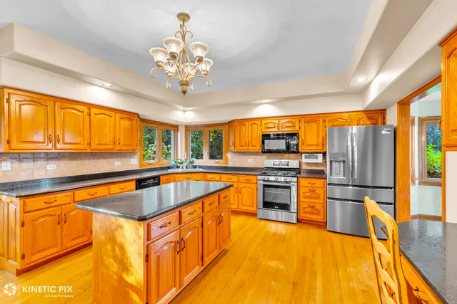 a kitchen with stainless steel appliances granite countertop a sink and cabinets
