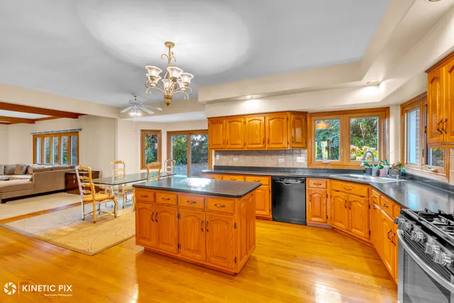 a large kitchen with lots of counter top space and dining table