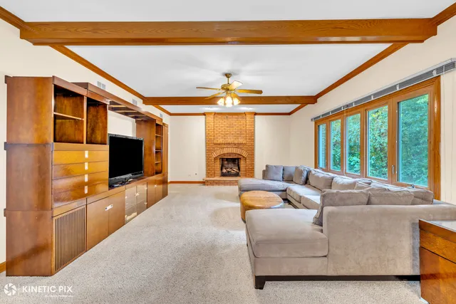 a living room with fireplace furniture and a flat screen tv