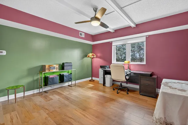 a work room with furniture and a wooden floor