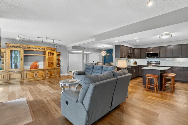a living room with furniture and kitchen view