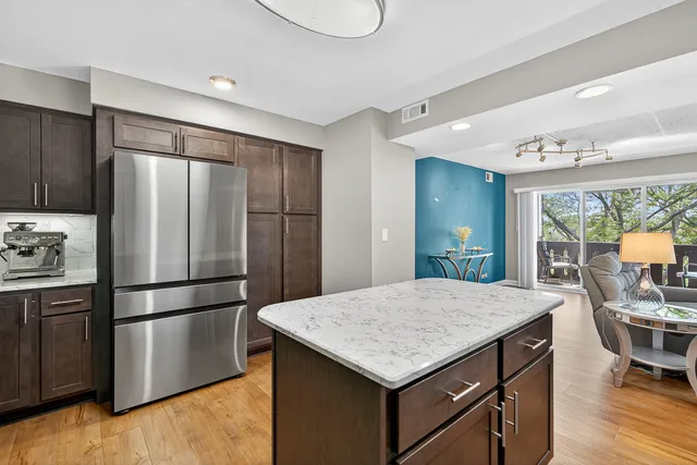 a kitchen with a refrigerator a sink and cabinets