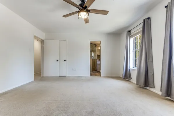 a view of empty room with ceiling fan
