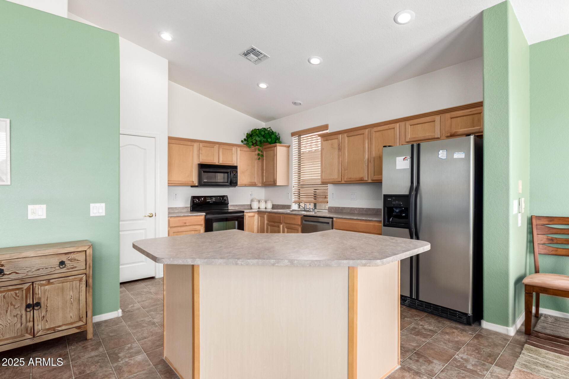 18131 West Addie Lane Surprise, AZ 85374 - Photo 13 of 31 a kitchen with stainless steel appliances granite countertop a sink stove and refrigerator