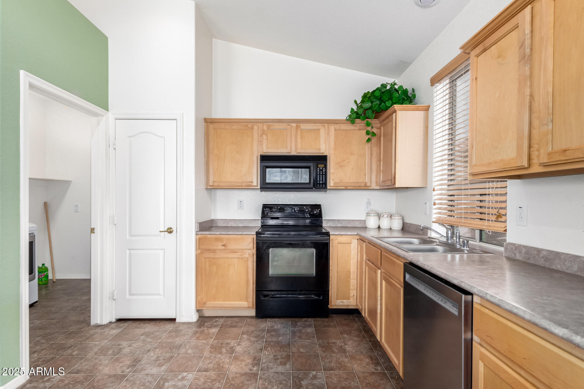 18131 West Addie Lane Surprise, AZ 85374 - Photo 14 of 31 a kitchen with a sink stove and refrigerator