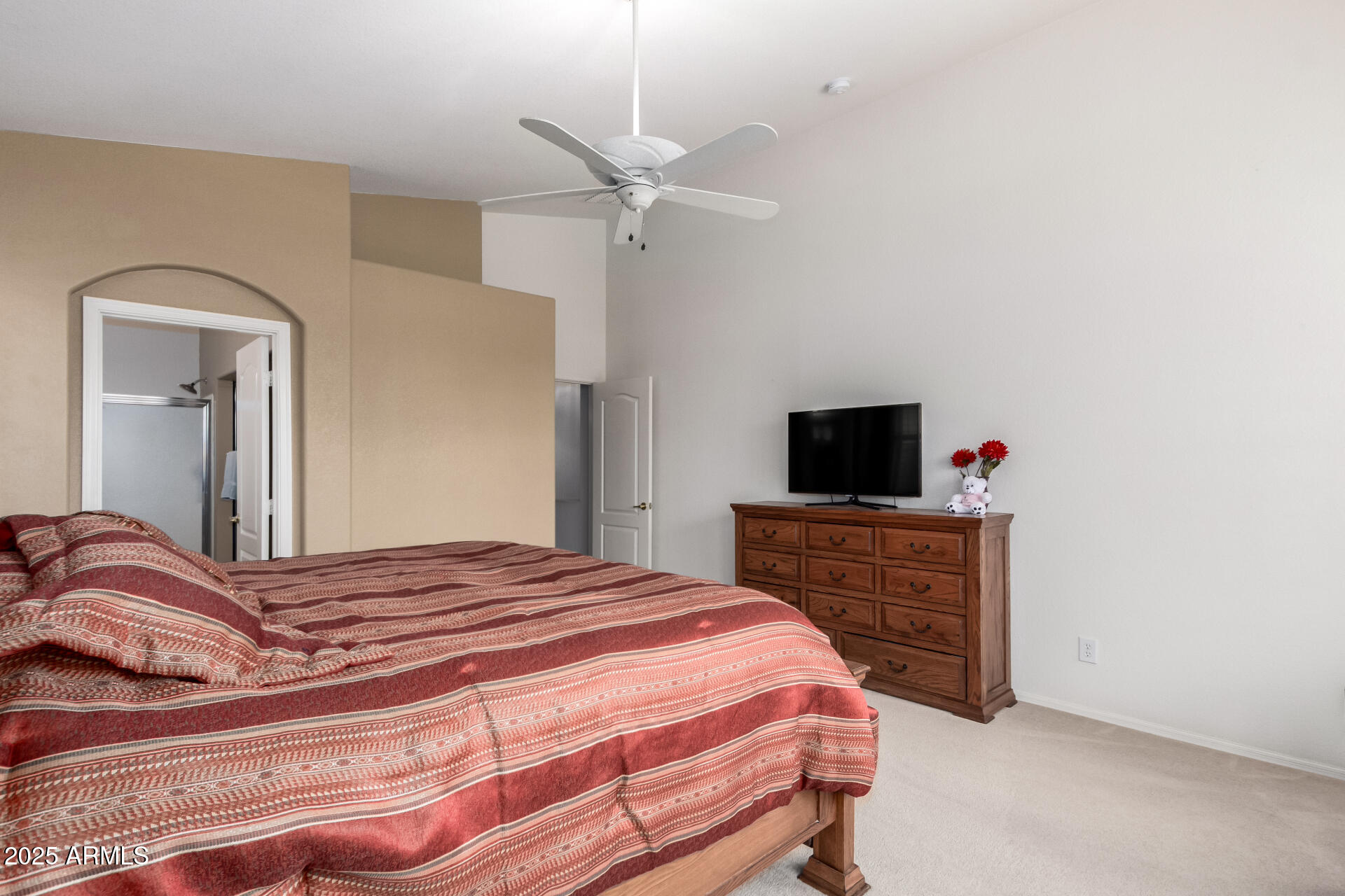 18131 West Addie Lane Surprise, AZ 85374 - Photo 19 of 31 a bedroom with a bed and a flat screen tv