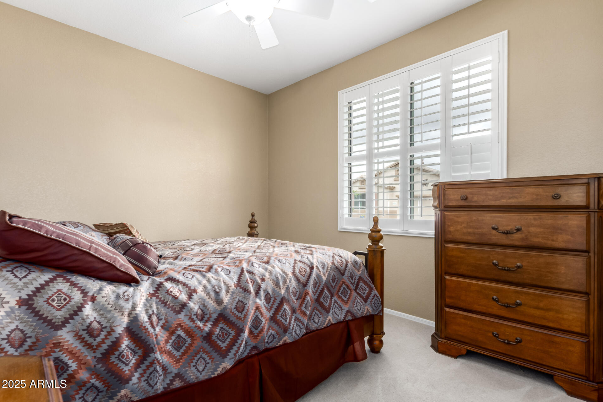 18131 West Addie Lane Surprise, AZ 85374 - Photo 21 of 31 a bedroom with a bed and a window