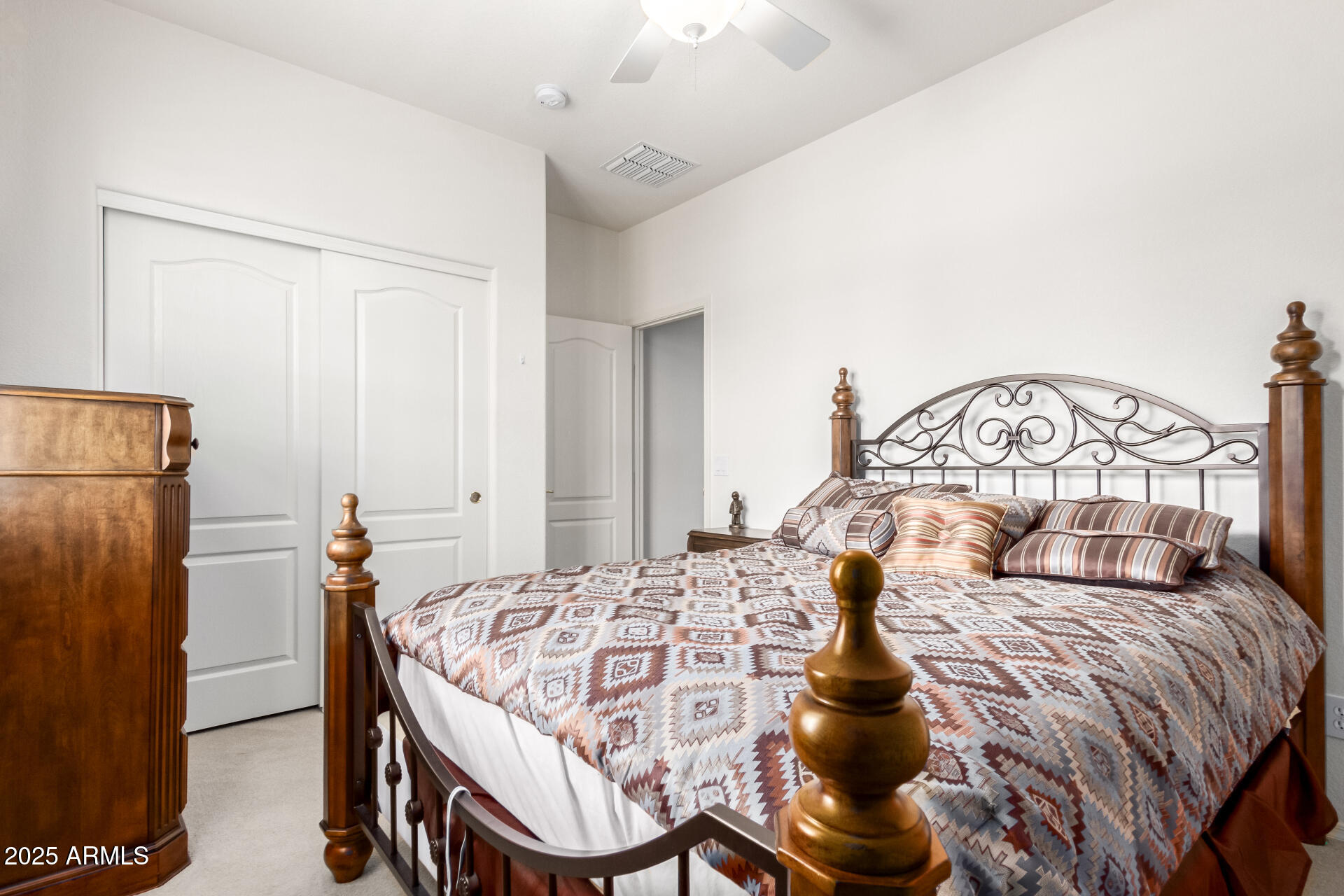 18131 West Addie Lane Surprise, AZ 85374 - Photo 22 of 31 a bedroom with a bed and a chandelier