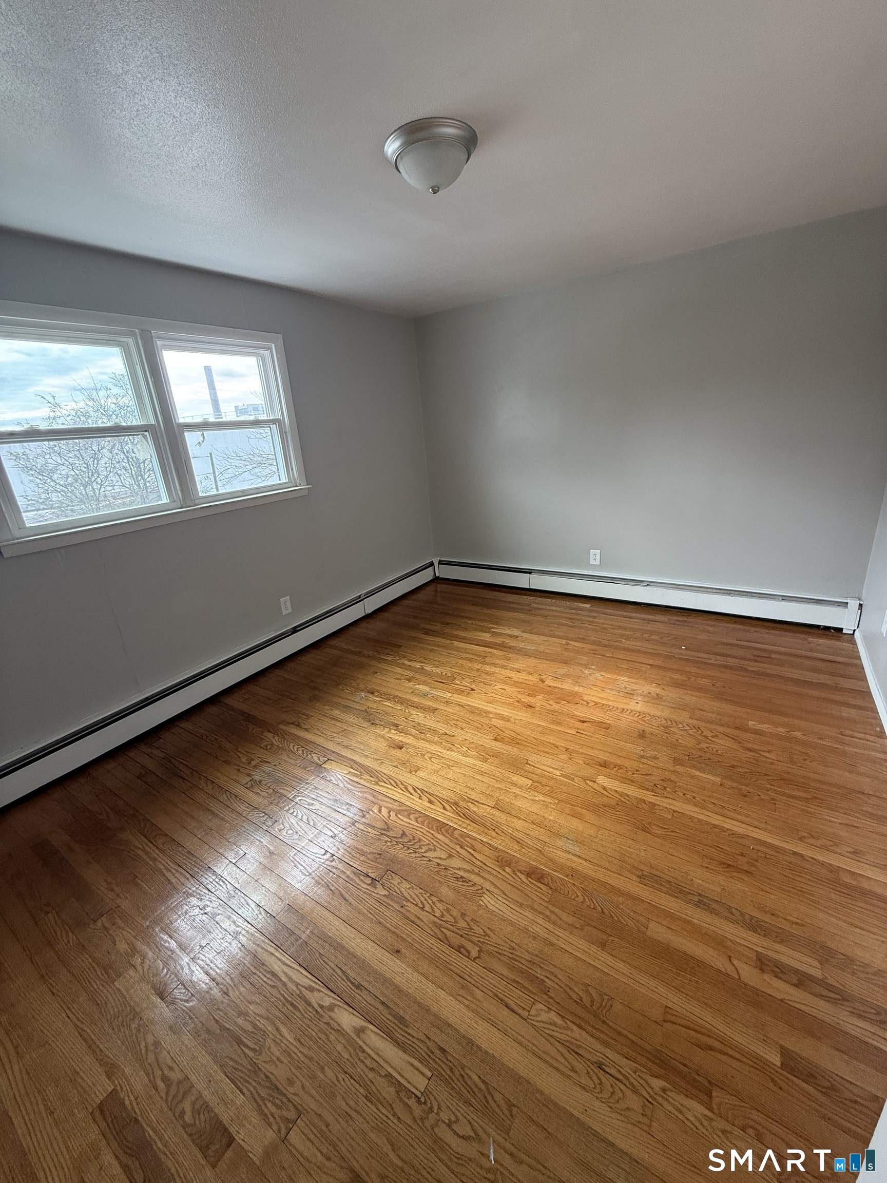 33 Allen Place New Haven, CT 06512 - Photo 14 of 23 a view of an empty room with wooden floor and a window