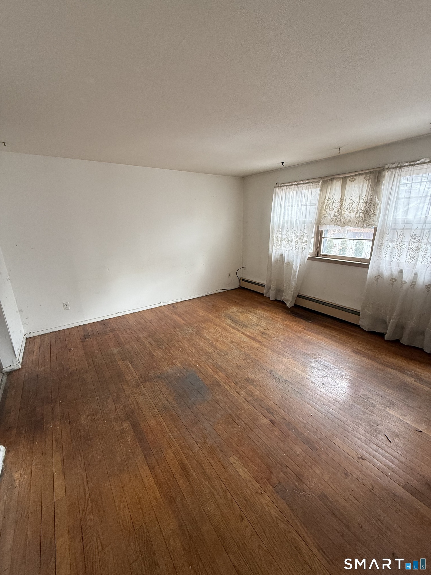 33 Allen Place New Haven, CT 06512 - Photo 16 of 23 an empty room with wooden floor and windows